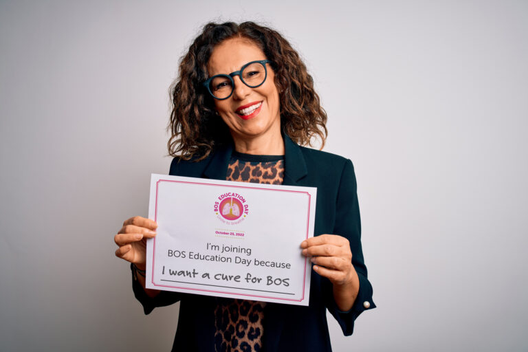 Woman holding sign about BOS Education Day